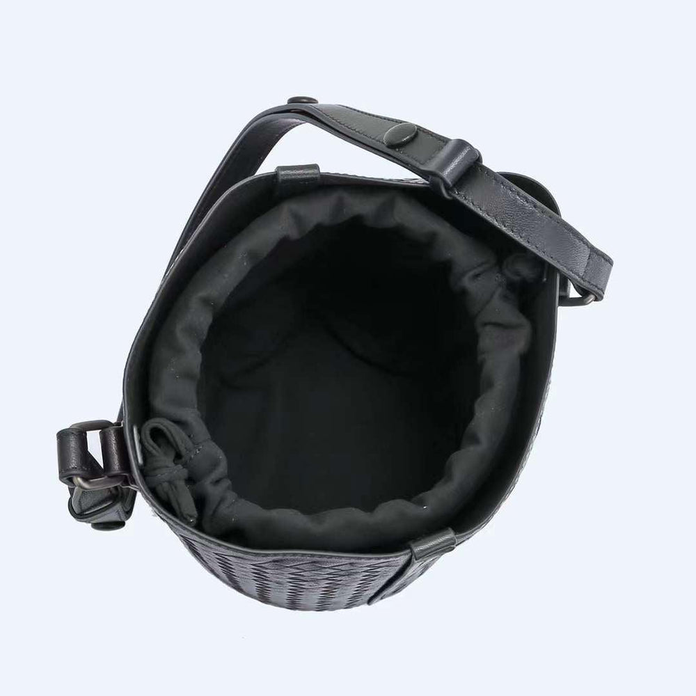 Top view of black woven lambskin leather bucket bag with adjustable strap and fabric lining.