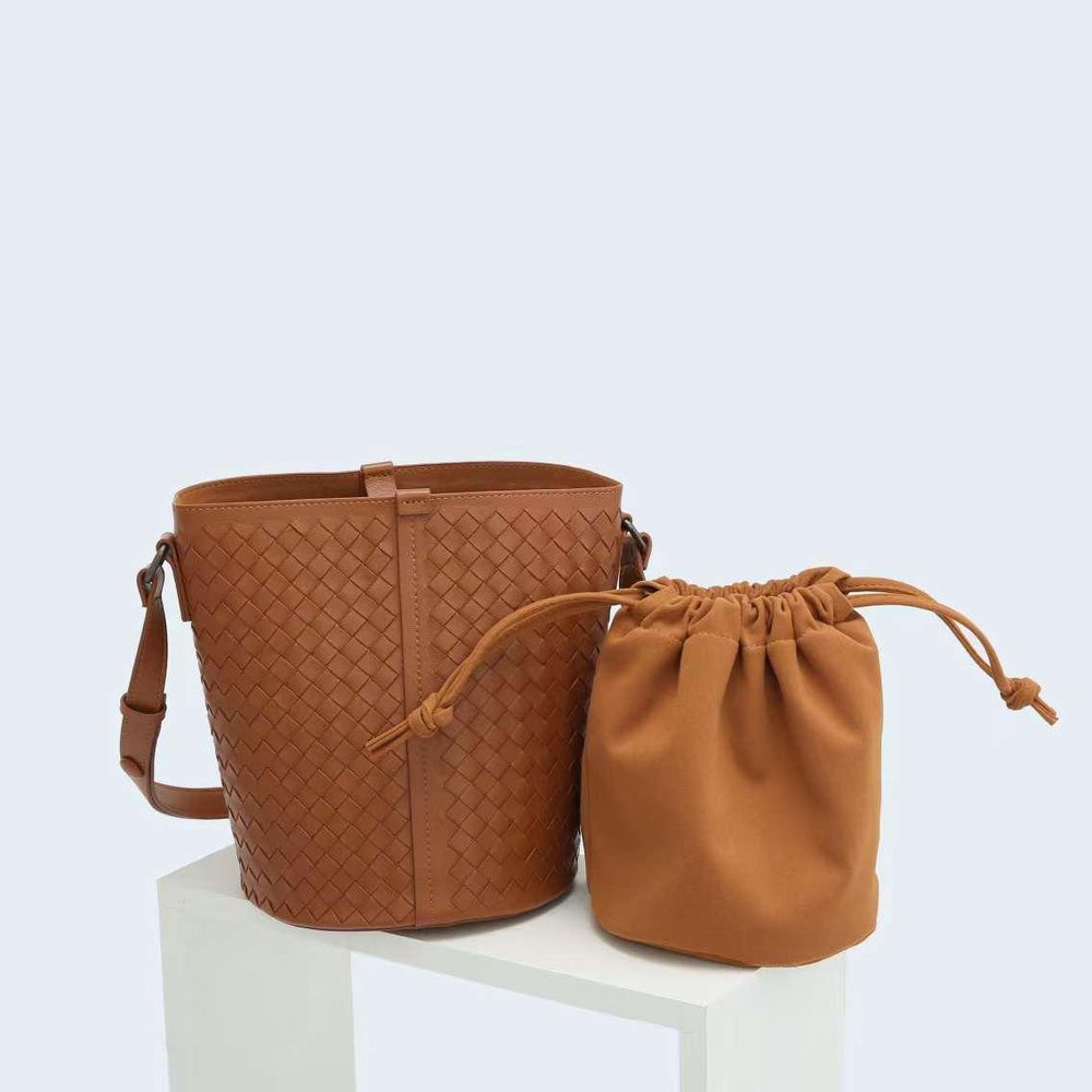 Brown lambskin woven leather bucket bag with matching drawstring pouch on white stand
