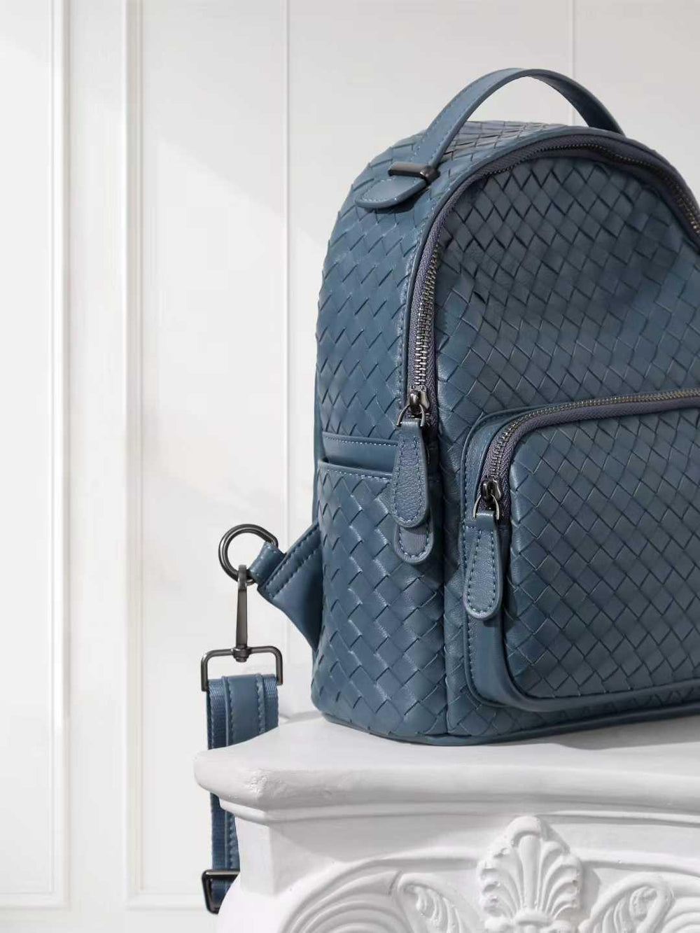 Blue handwoven lambskin leather backpack with quilted texture and front zipper pocket
