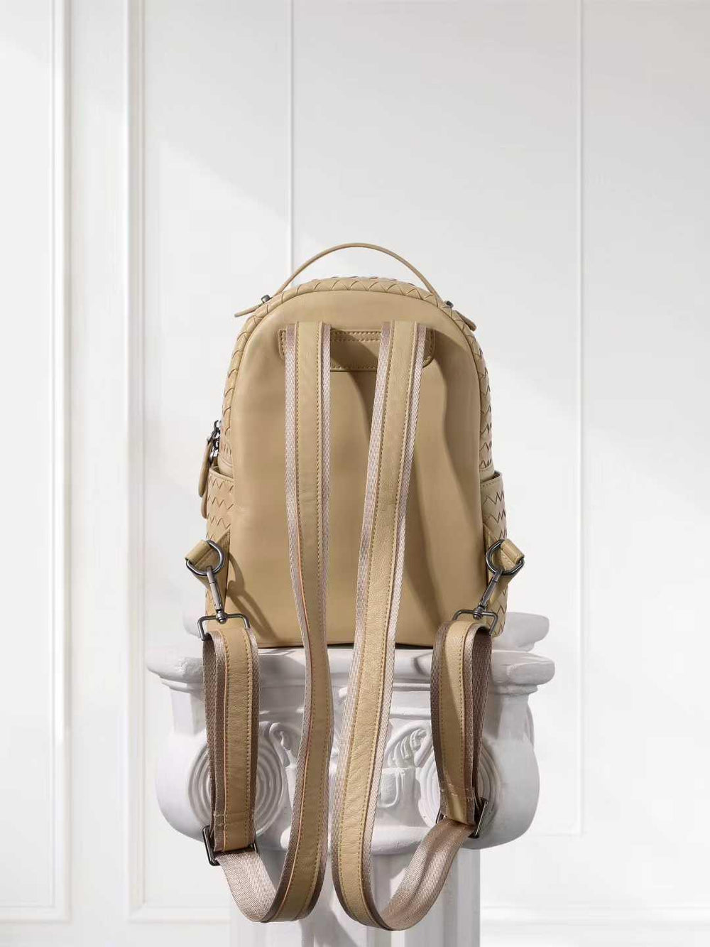 Small beige lambskin leather backpack with hand-woven quilting and adjustable straps