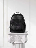 Black woven lambskin leather small backpack with quilted texture on white pedestal