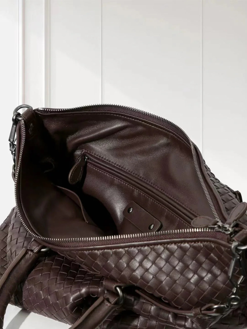 Interior view of large black intrecciato lambskin leather tote bag with zipper and spacious compartments