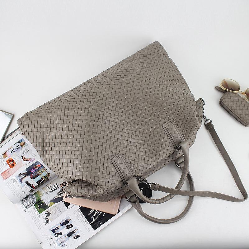 Large taupe woven leather tote bag with handles and detachable strap on a magazine, chic accessory