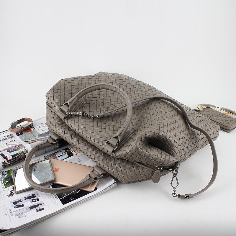 Taupe woven leather tote bag with top handles and shoulder strap, displayed on magazines.