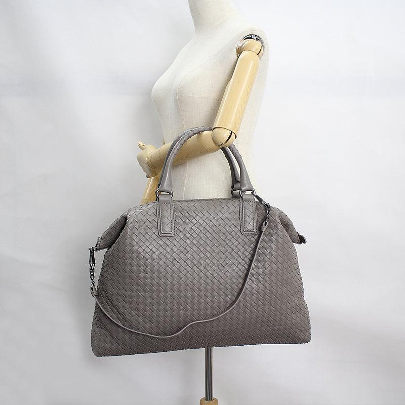 Large grey intrecciato lambskin leather tote bag with double handles and shoulder strap on mannequin