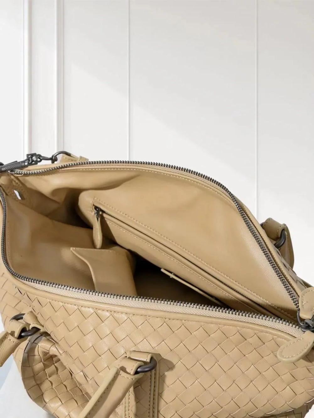 Interior view of beige woven lambskin leather tote bag with zip pocket and spacious compartments