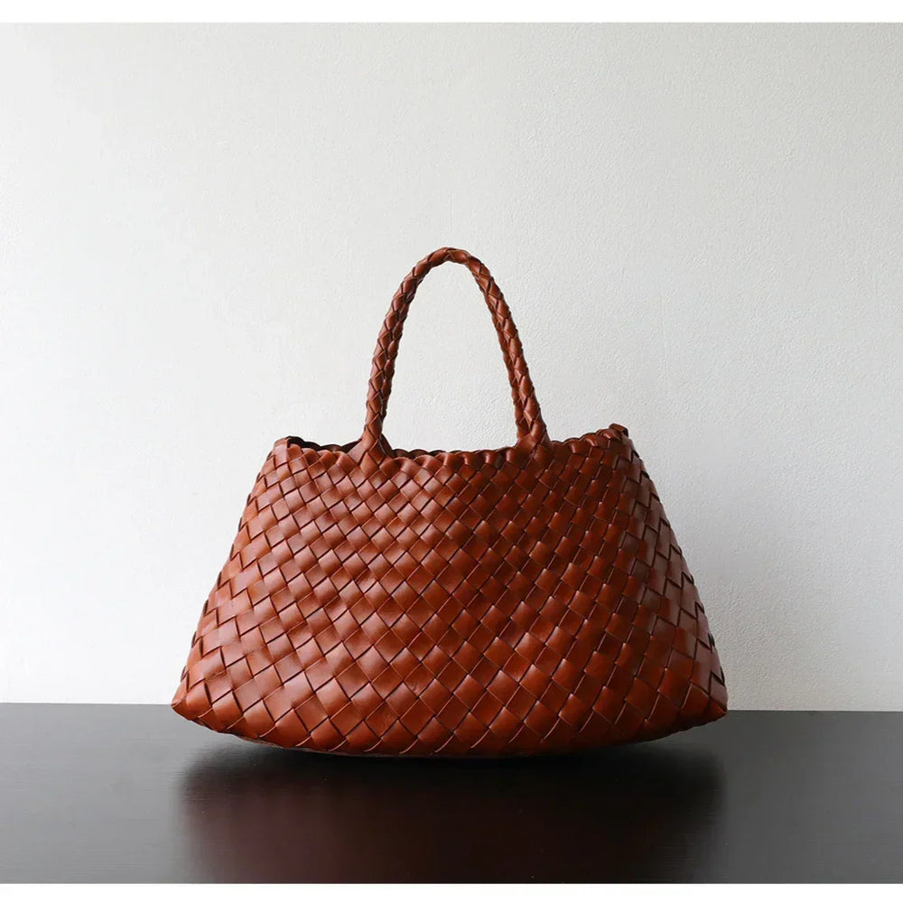 Brown woven leather hobo shoulder bag with trapezoidal shape and braided long handle