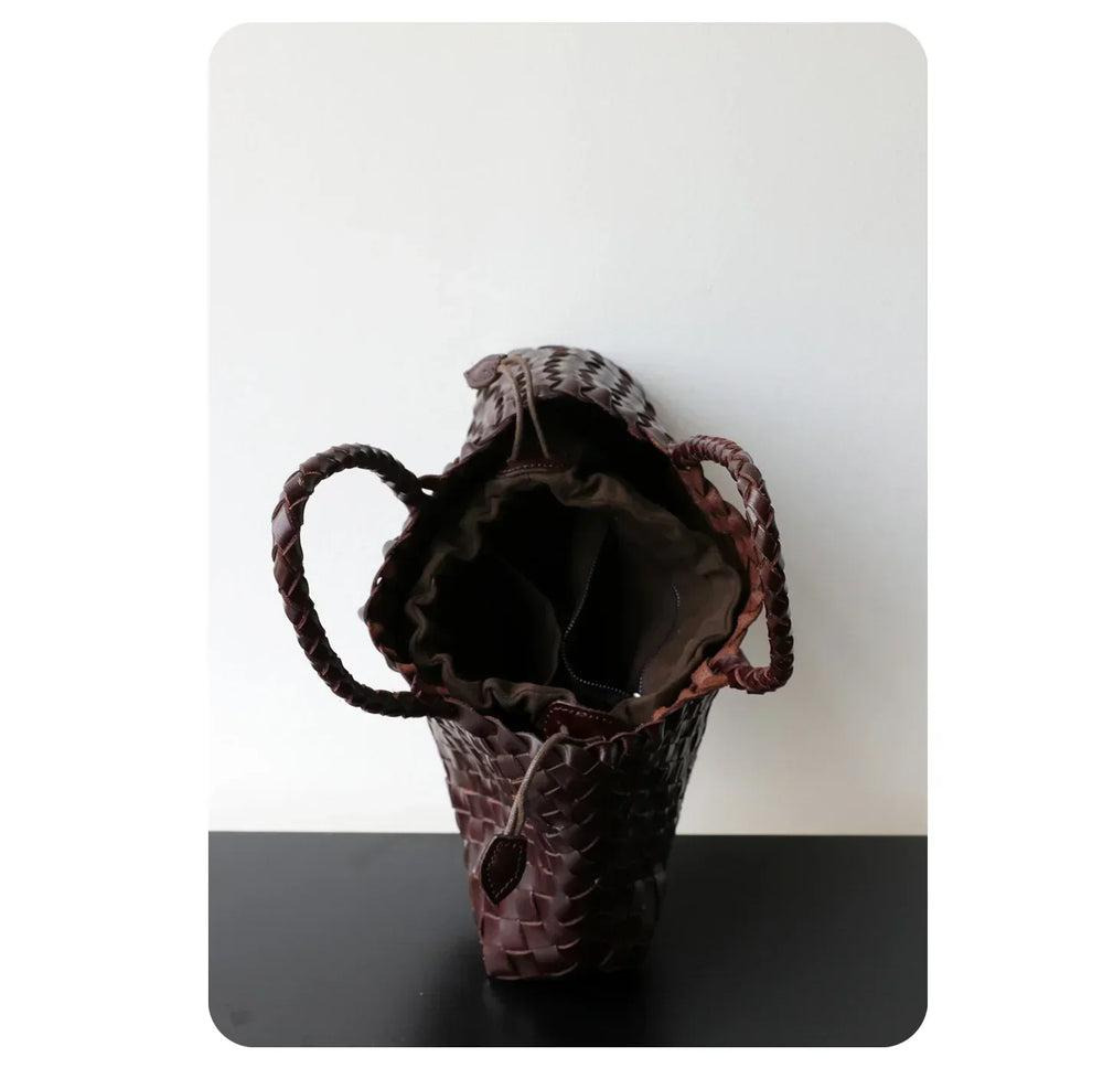 Brown woven leather trapezoidal hobo shoulder bag with long handles and drawstring closure