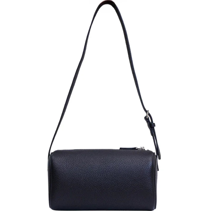 Mini black lambskin leather Boston bag with long adjustable strap and boxy shape on white background