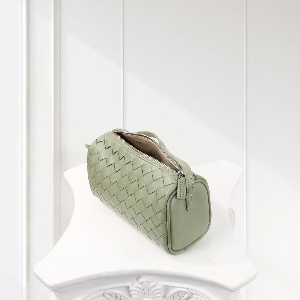 Sage green woven lambskin leather mini Boston bag with zipper on white surface