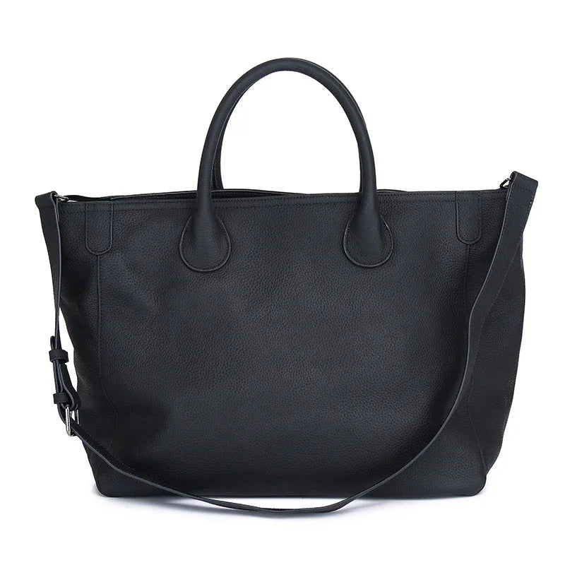 Large black leather tote bag with dual handles and detachable shoulder strap