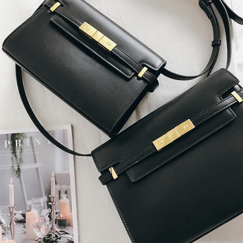 Black leather crossbody bags with gold hardware on a light surface, minimal shoulder bags.