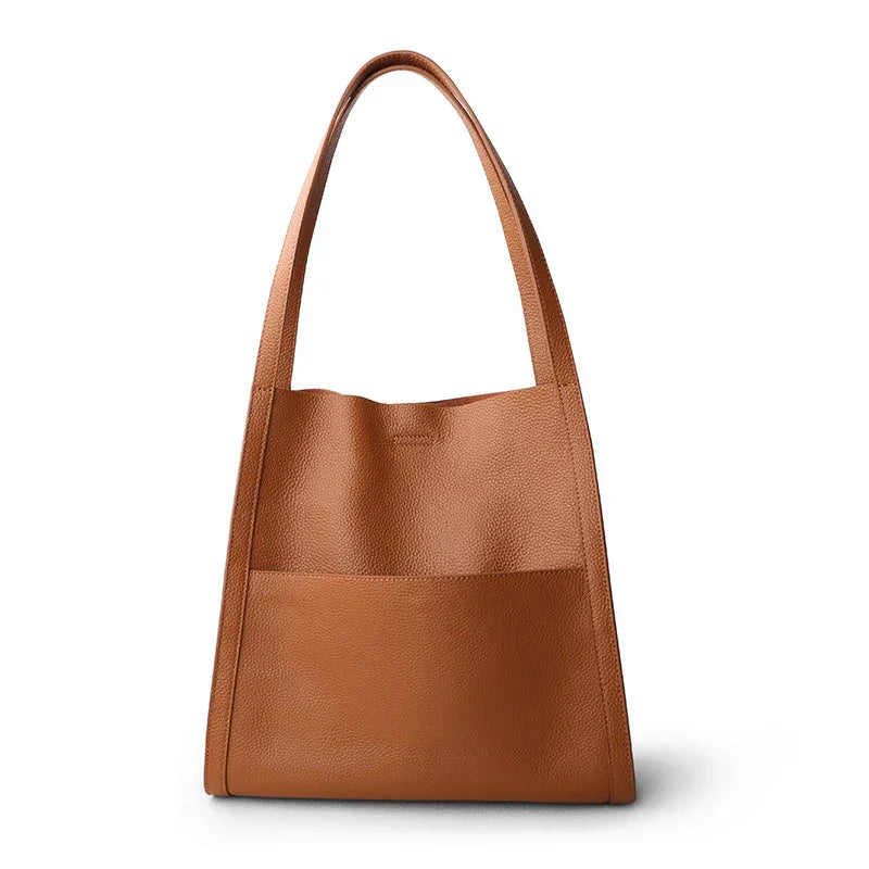 Brown grain cowhide leather tote bag with wide shoulder straps and front pocket, minimalist design