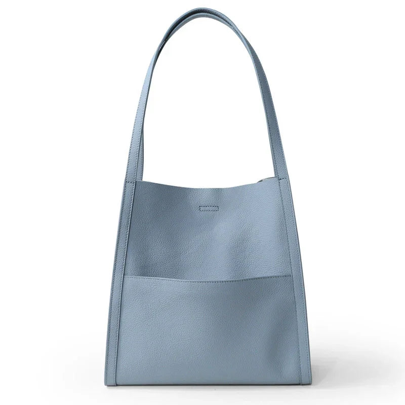 Light blue grain cowhide leather tote bag with minimalist design and wide shoulder strap