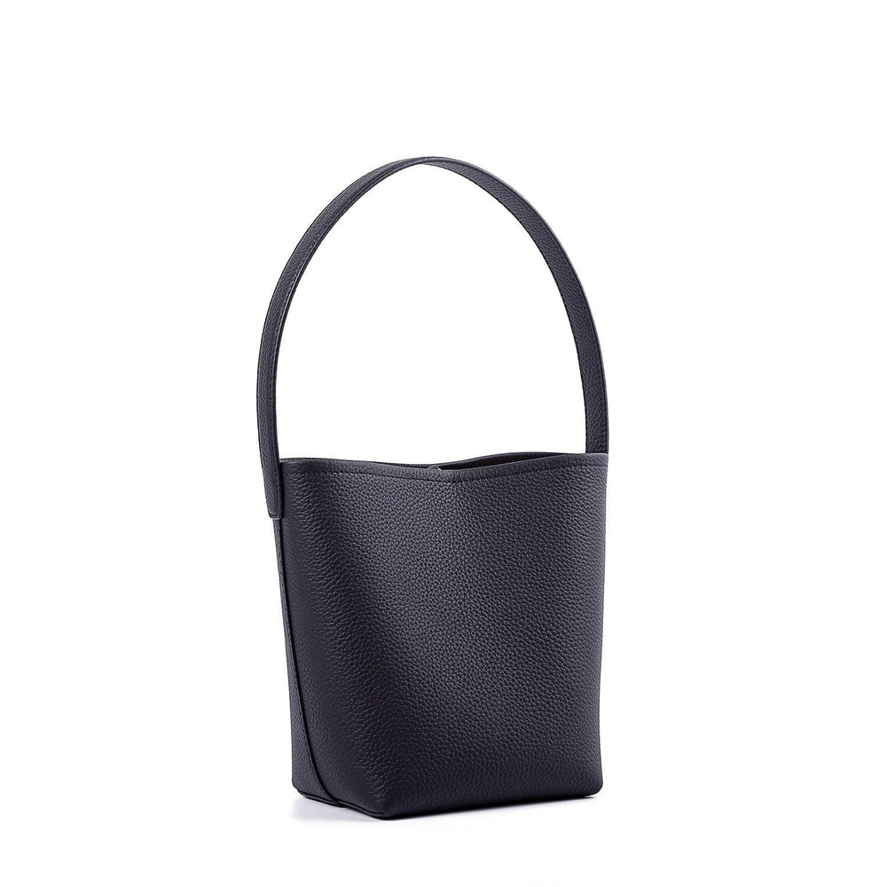 Minimalist black leather bucket bag with a single top handle on a white background