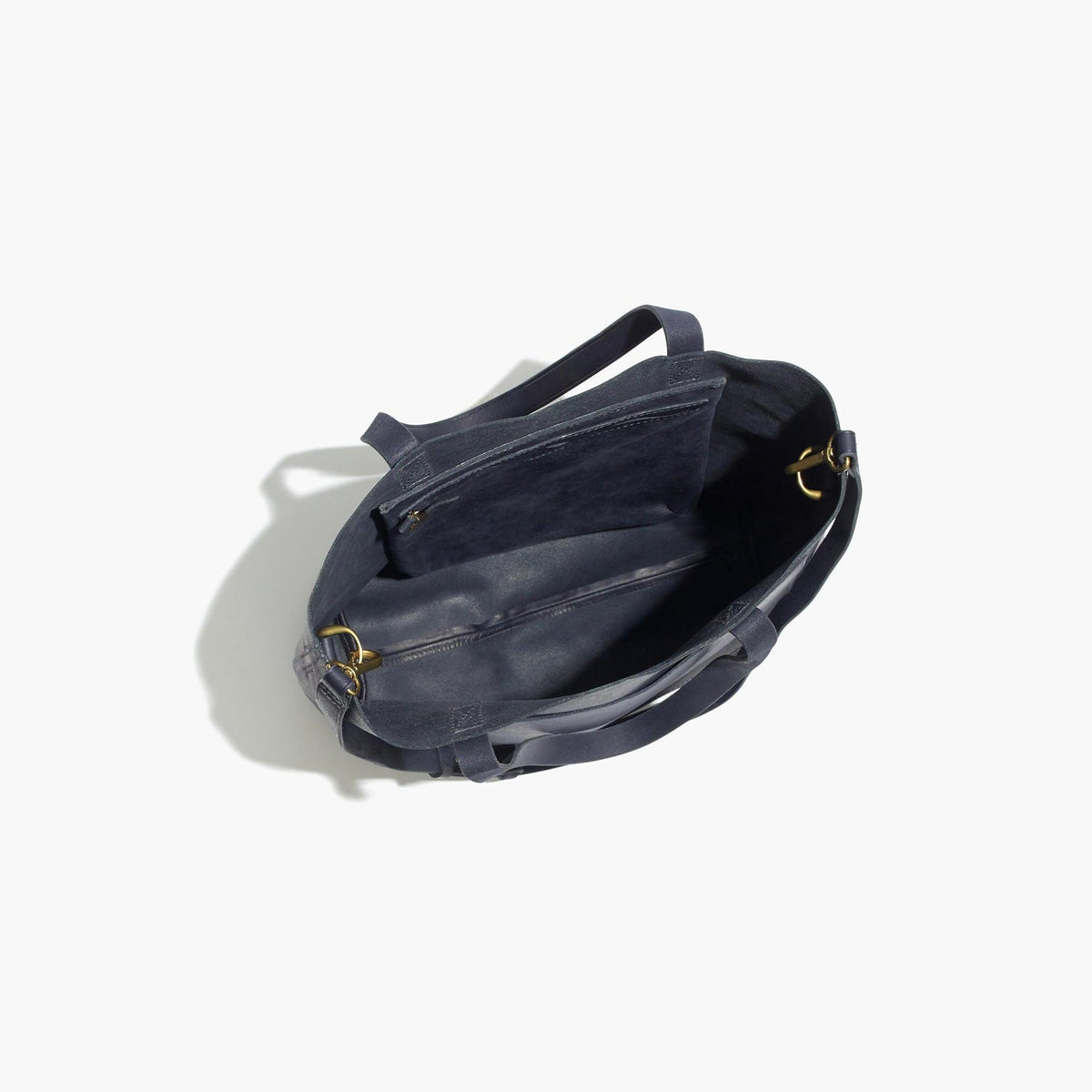 Top view of open minimalist full grain leather tote bag with spacious interior and zip pocket