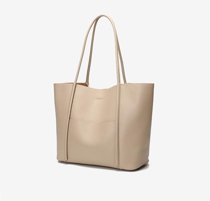 Minimalist beige genuine leather tote bag with top handles and front pocket on white background
