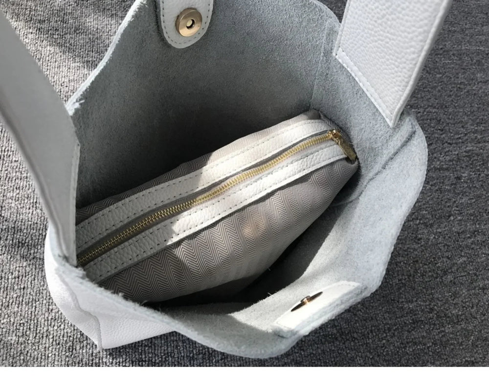Minimalist pebbled cowhide leather bucket bag with wide shoulder strap and inner zip pouch