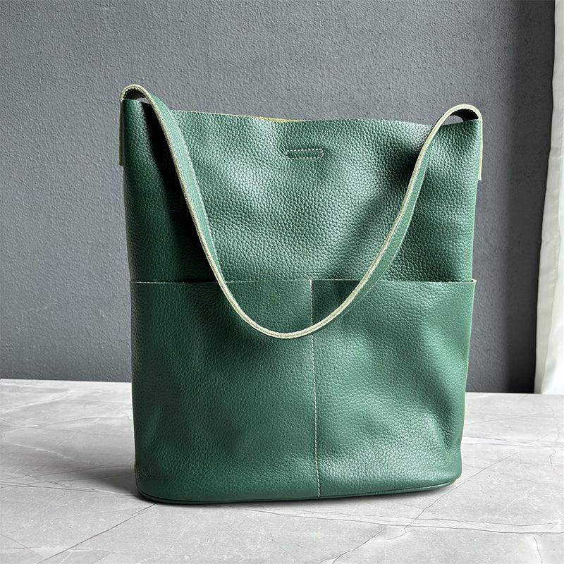 Green cowhide leather tote bag with two front pockets and minimalist design