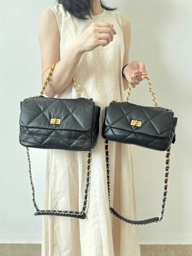 Woman holding two black quilted leather shoulder bags with gold chain straps and turn-lock closures