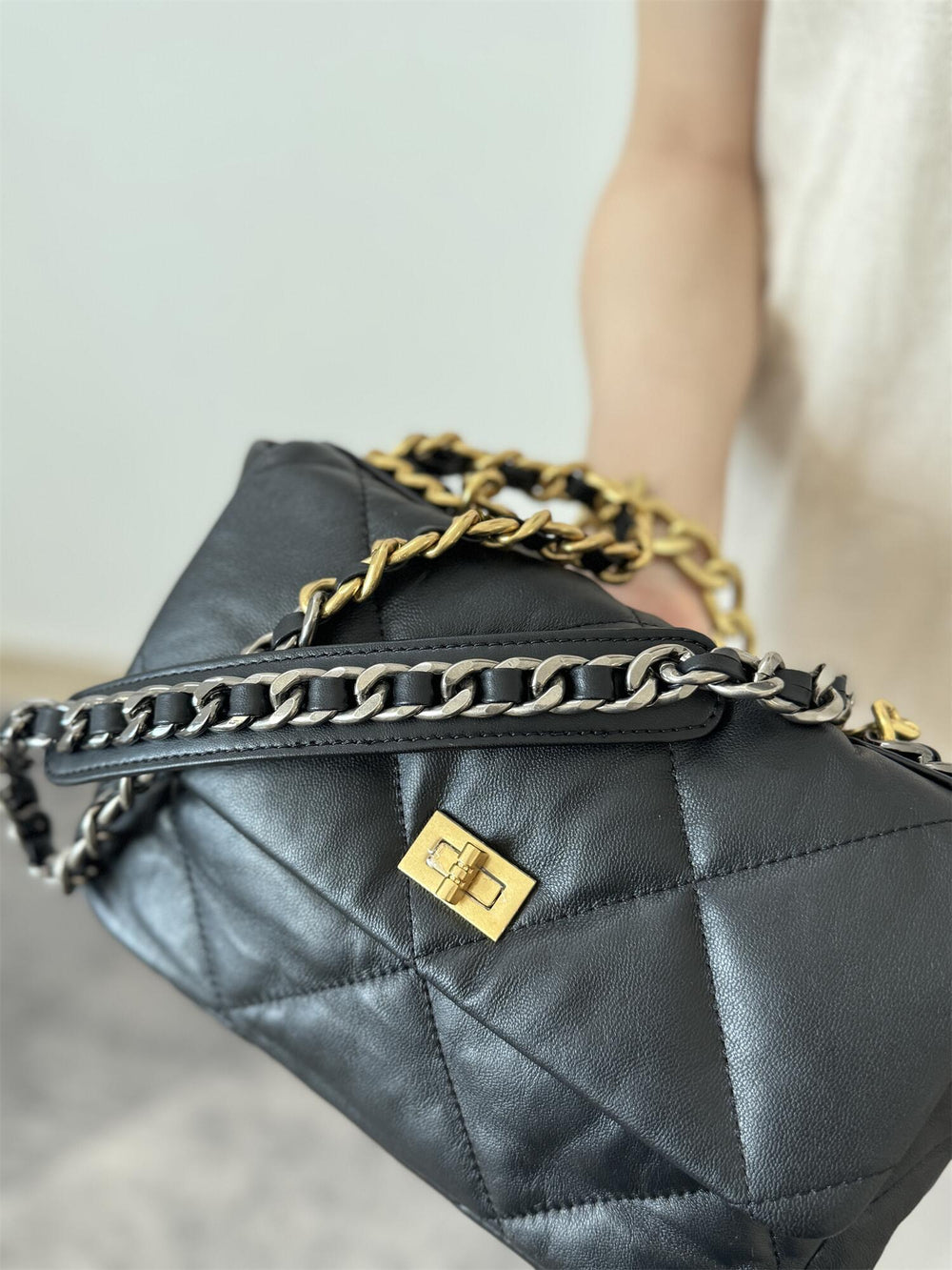 Black quilted genuine leather shoulder bag with gold chain strap and turn-lock closure