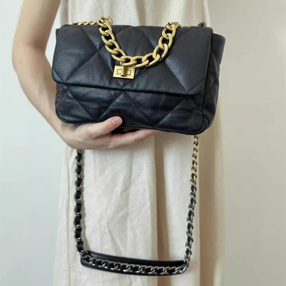 Quilted black leather shoulder bag with gold chain strap and turn-lock clasp