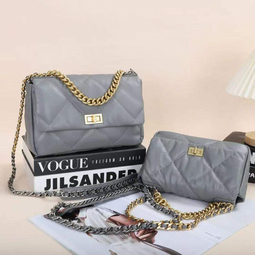 Two grey quilted genuine leather shoulder bags with gold chain straps and turn-lock closures.