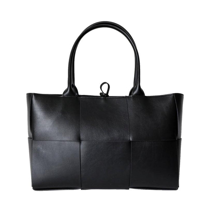 Large black quilted leather tote bag with minimalist top handles and classic woven design