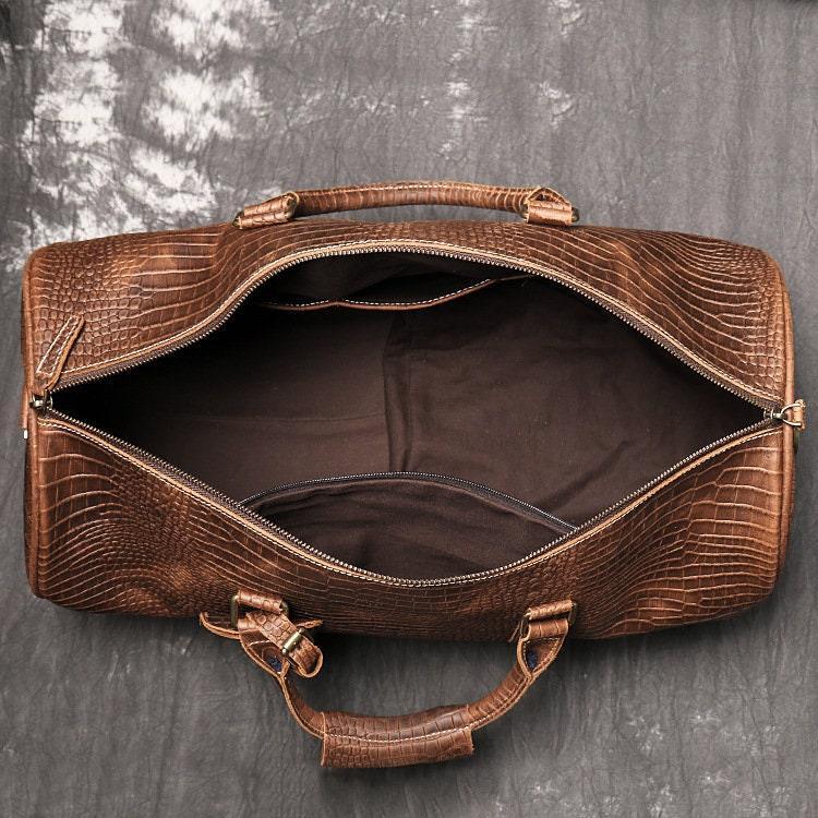 Open brown full-grain leather duffle bag with crocodile texture and spacious interior
