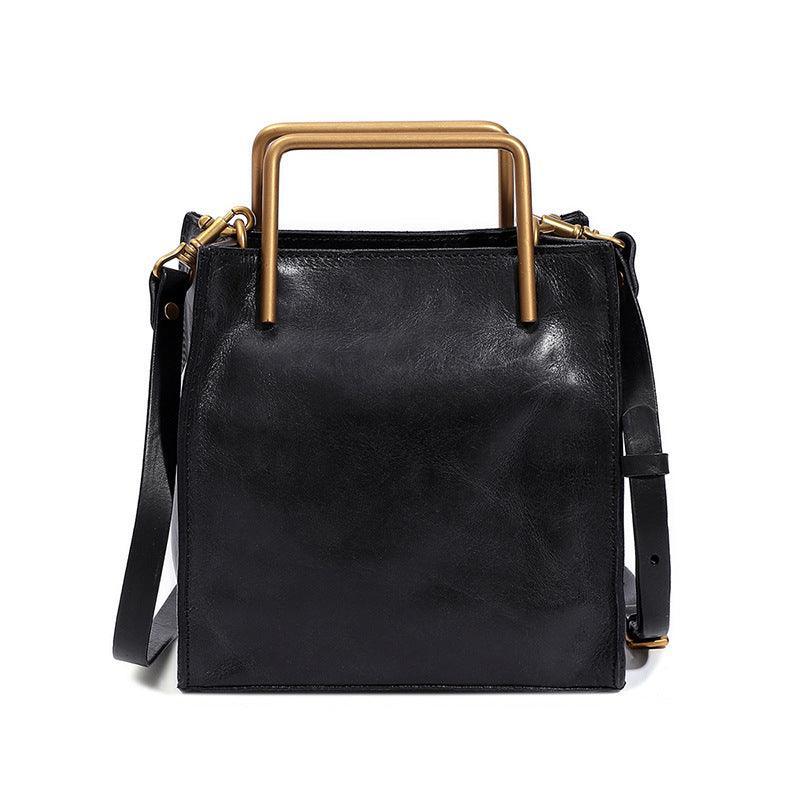 Black Italian leather shoulder bag with gold handles and adjustable strap, square design