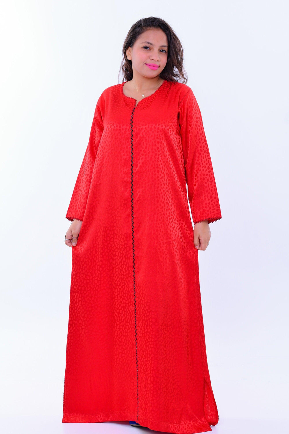 Woman wearing long red boho silk kaftan dress with wide sleeves and subtle pattern