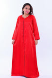 Woman wearing long red boho silk kaftan dress with wide sleeves and subtle pattern