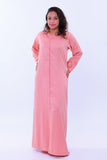 Woman wearing pink handcrafted kaftan maxi dress with long sleeves and subtle pattern