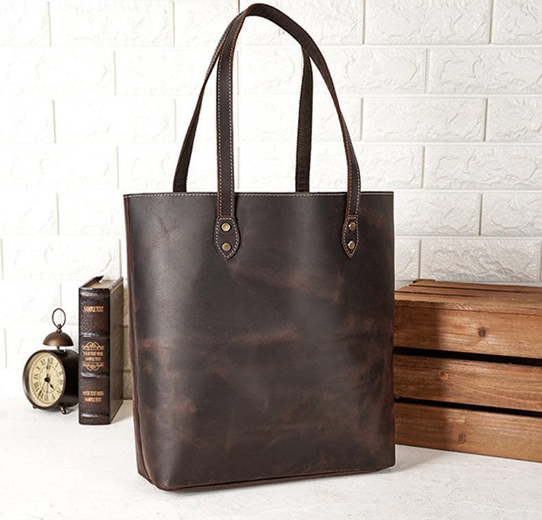 Handcrafted large brown leather tote bag with double handles on a white background