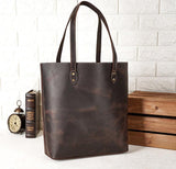Handcrafted large brown leather tote bag with double handles on a white background