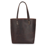 Handcrafted large brown leather tote bag with double handles on a white background