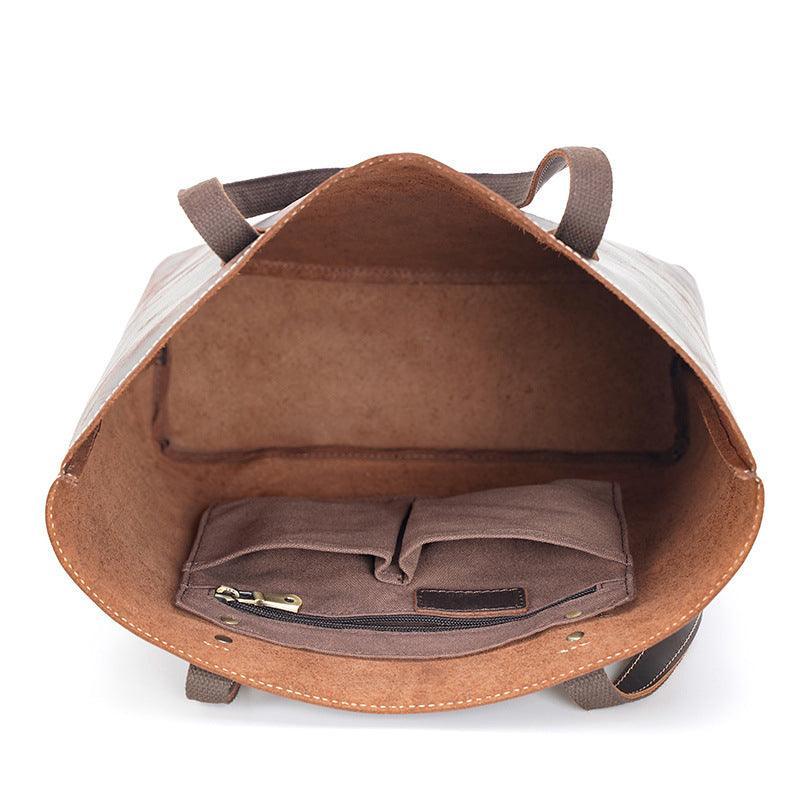 Interior view of a large handcrafted leather tote bag with inner pockets and suede lining