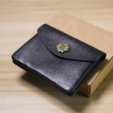 Black handcrafted minimalist leather slim wallet with floral metal clasp on gift box