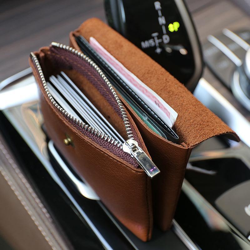 Handcrafted minimalist leather slim wallet for women with zipper, open displaying cards and cash.