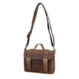 Handcrafted vintage style brown leather shoulder messenger bag with adjustable strap and buckle closure on a white background.