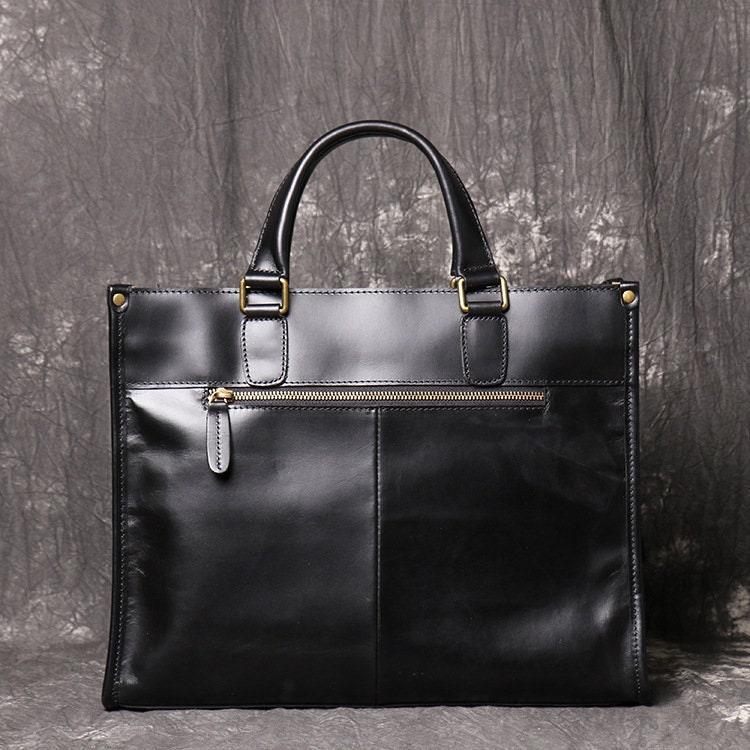 Black full grain leather messenger bag with top handles and front zipper pocket