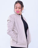 Woman modeling slim fit genuine leather biker jacket in light grey with zip pockets