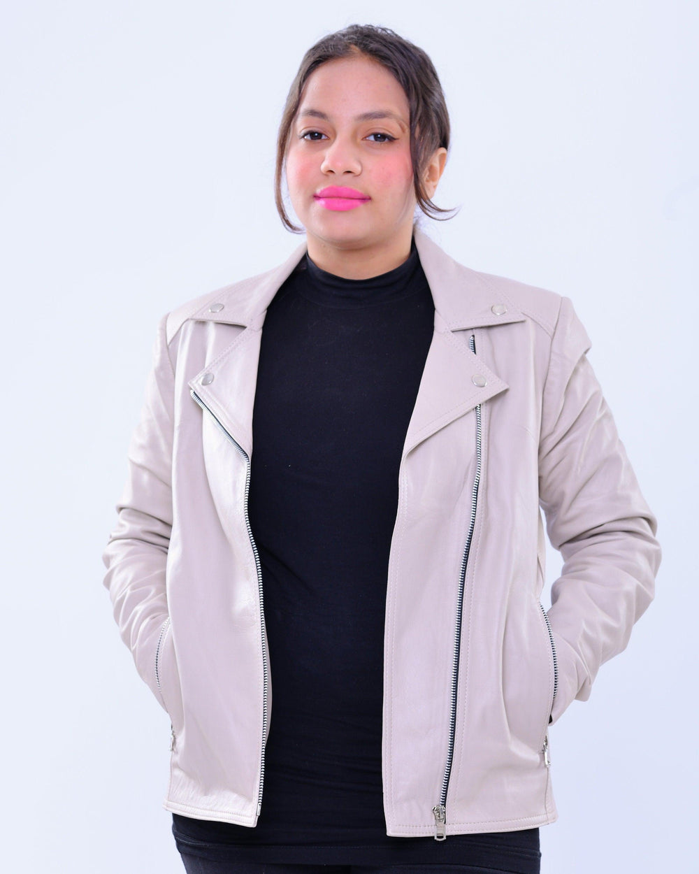 Woman wearing slim fit grey genuine leather biker jacket with zip details