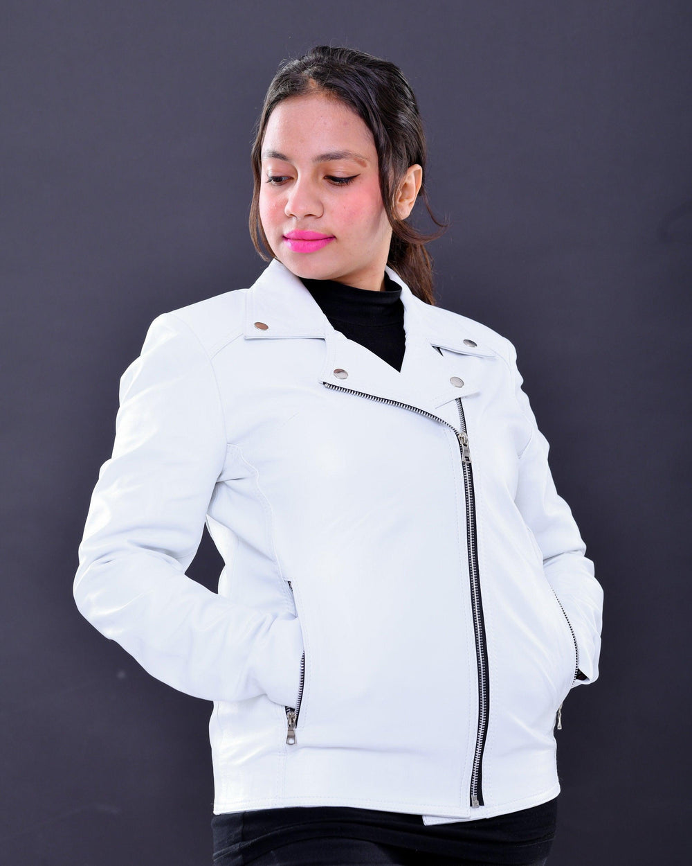 Woman wearing slim fit white genuine leather biker jacket with silver zippers