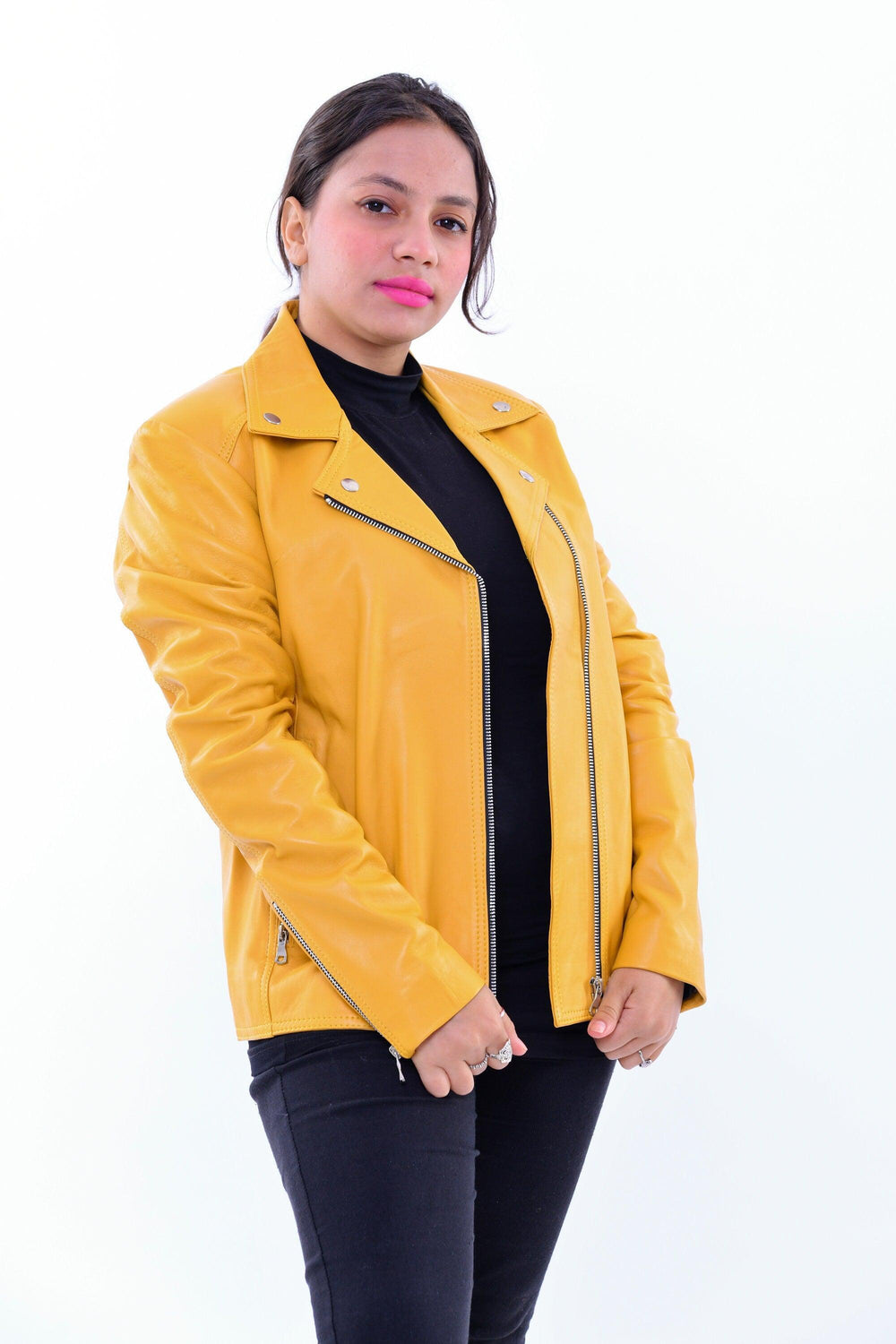 Woman wearing slim fit yellow genuine leather biker jacket against white background