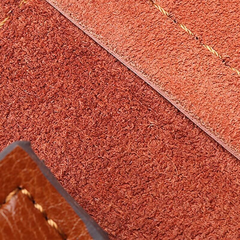 Close-up of brown genuine leather handbag interior with visible stitching and suede texture