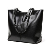 Black leather tote bag with double handles, minimalist design, large daily handbag