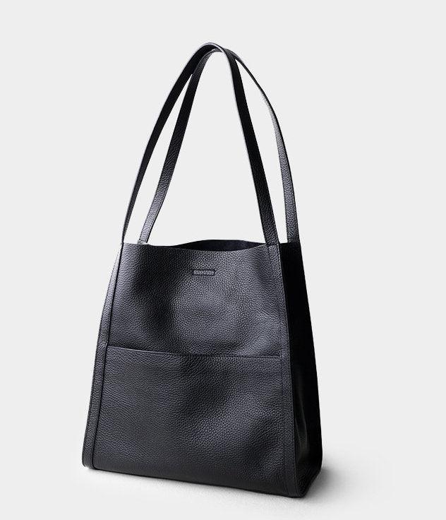 Black grain cowhide leather tote bag with double shoulder straps on white background