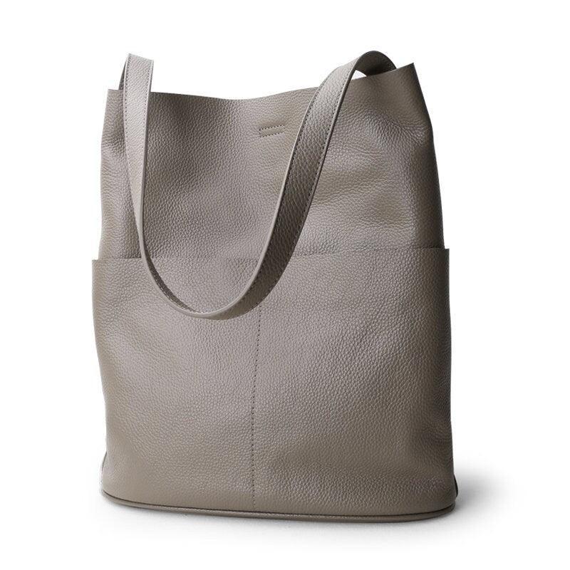 Oak cowhide leather tote bag with two front pockets, soft minimalist design, neutral background