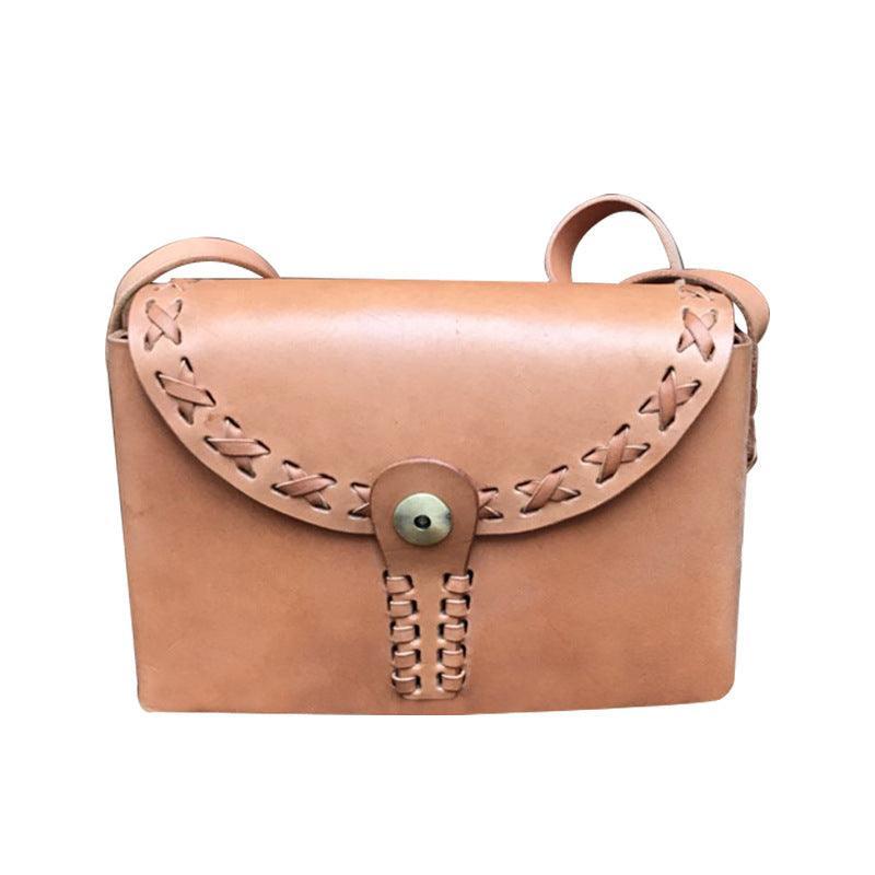 Small handcrafted leather shoulder bag with stitched flap and brass button closure